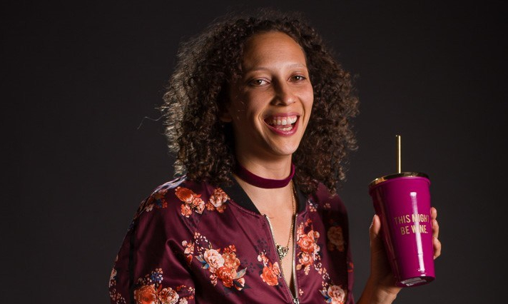 Molly smiling with a cup